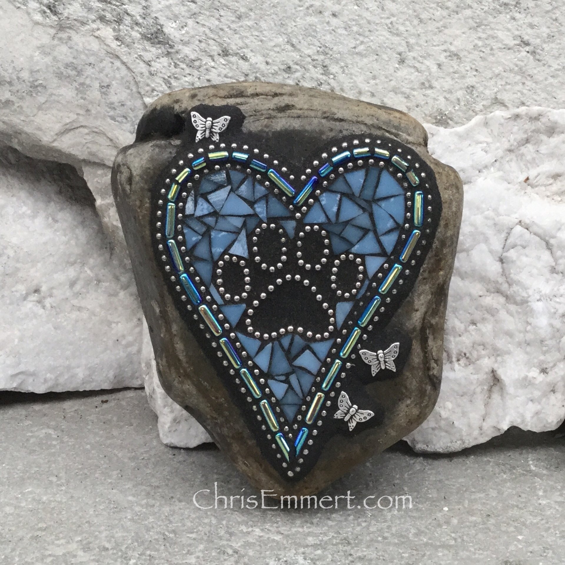 Blue mosaic heart with paw print.